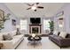 Bright living room featuring a fireplace, two sofas, and natural light from the surrounding windows at 7618 Ballyshannon St, Indianapolis, IN 46217