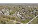 Wide aerial shot of a charming residential area featuring tree-covered streets and a variety of houses under clear skies at 775 W Hawthorne St, Zionsville, IN 46077
