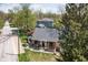 Aerial shot of a charming home with mature landscaping, a red umbrella on the balcony, and a well-manicured lawn at 775 W Hawthorne St, Zionsville, IN 46077