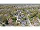 Beautiful aerial view of a tree-lined residential area with a mix of houses, roads, and lush greenery on a sunny day at 775 W Hawthorne St, Zionsville, IN 46077