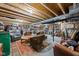 Unfinished basement area, featuring exposed ceiling, concrete flooring and an eclectic assortment of furniture and storage items at 775 W Hawthorne St, Zionsville, IN 46077