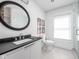 Modern bathroom featuring a sleek black countertop vanity and walk-in shower at 775 W Hawthorne St, Zionsville, IN 46077