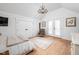 Bright bedroom with wood floors, a chandelier, and access to a balcony at 775 W Hawthorne St, Zionsville, IN 46077