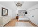 Cozy bedroom with wood floors, chandelier, and a dresser at 775 W Hawthorne St, Zionsville, IN 46077