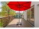 Inviting deck space featuring a red umbrella, wood floors and black railings offers a great outdoor spot at 775 W Hawthorne St, Zionsville, IN 46077