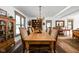Formal dining room boasts a large wooden table, chandelier, and windows bringing light to the space at 775 W Hawthorne St, Zionsville, IN 46077