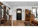 Elegant entryway featuring a striking black door with stained glass and decorative wood accents, plus a hardwood floor at 775 W Hawthorne St, Zionsville, IN 46077