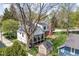 Charming two-story home featuring a cozy front porch and a well-maintained, lush green yard with a storage shed at 775 W Hawthorne St, Zionsville, IN 46077