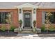 Elegant front entrance with stone steps, decorative plants, and a beautiful door at 775 W Hawthorne St, Zionsville, IN 46077