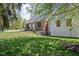 Charming brick home with green lawn, mature trees, and stone steps at 775 W Hawthorne St, Zionsville, IN 46077