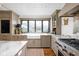 Bright kitchen showcases marble countertops, shaker cabinets, and stainless steel appliances with a window view at 775 W Hawthorne St, Zionsville, IN 46077