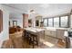 Open kitchen and living room with large island, stainless appliances, and hardwood floors at 775 W Hawthorne St, Zionsville, IN 46077