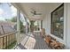 Covered porch with wood floors, ceiling fan, and railing overlooking the yard at 775 W Hawthorne St, Zionsville, IN 46077