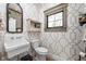 Stylish powder room with patterned wallpaper, a pedestal sink, and a window allowing natural light at 775 W Hawthorne St, Zionsville, IN 46077