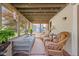 Cozy sunroom with wicker furniture, string lights, and views of the lush backyard at 775 W Hawthorne St, Zionsville, IN 46077