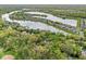 Expansive aerial view of a residential area featuring multiple lakes, townhomes, and lush green spaces, a peaceful retreat at 7786 Harbour Isle, Indianapolis, IN 46240