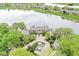 Scenic aerial view of lakeside townhomes with a circular driveway and green surroundings, showcasing the community's layout at 7786 Harbour Isle, Indianapolis, IN 46240