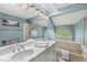 Bright bathroom with double vanity, shower, tub, and unique arched window at 7786 Harbour Isle, Indianapolis, IN 46240