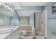 Bathroom featuring a glass-enclosed shower and bathtub with natural light at 7786 Harbour Isle, Indianapolis, IN 46240