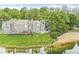 Beautifully maintained waterfront property with lush lawn and serene lake views from the private decks at 7786 Harbour Isle, Indianapolis, IN 46240