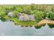 Stunning lakefront property with lush greenery and a private beach, offering a serene and picturesque living environment at 7786 Harbour Isle, Indianapolis, IN 46240