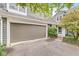 Attached garage and well-maintained exterior with landscaped entryway, providing convenience and curb appeal at 7786 Harbour Isle, Indianapolis, IN 46240