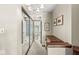 Hallway with chandelier and large mirror doors leading to a bathroom, enhancing space and light at 7786 Harbour Isle, Indianapolis, IN 46240