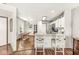 Bright, white kitchen features granite countertops, a breakfast bar, and an adjacent dining area at 7786 Harbour Isle, Indianapolis, IN 46240