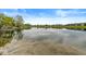 Expansive lake with clear water reflecting the sky and surrounding community offering a serene escape at 7786 Harbour Isle, Indianapolis, IN 46240