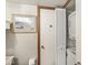 Convenient in-bathroom laundry area with stacked washer and dryer, maximizing space and efficiency at 7786 Harbour Isle, Indianapolis, IN 46240