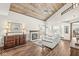 The living room features a vaulted wood ceiling, fireplace, and large windows offering an inviting space at 7786 Harbour Isle, Indianapolis, IN 46240
