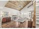 The living room features a vaulted wood ceiling, fireplace, and large windows offering an inviting space at 7786 Harbour Isle, Indianapolis, IN 46240