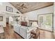 Comfortable living room with vaulted wood ceiling, fireplace, access to patio, and open view to the kitchen at 7786 Harbour Isle, Indianapolis, IN 46240