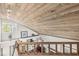 Loft area featuring wood-paneled ceiling, natural light, and open railing overlooking the lower level at 7786 Harbour Isle, Indianapolis, IN 46240