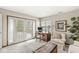 Inviting office with a charming desk, comfortable chair, and bright natural light from large windows at 7786 Harbour Isle, Indianapolis, IN 46240