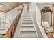 A carpeted staircase with wooden railings leading to the upper level provides a seamless transition at 7786 Harbour Isle, Indianapolis, IN 46240