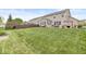 Expansive backyard featuring a well-maintained lawn, privacy fence, and outdoor seating area at 7829 Hedgehop Dr, Zionsville, IN 46077