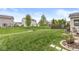 Spacious backyard featuring a lush lawn and mature trees, perfect for outdoor activities at 7829 Hedgehop Dr, Zionsville, IN 46077