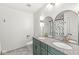 Modern bathroom features dual sinks, granite vanity, decorative mirrors, and stylish herringbone tiling at 7829 Hedgehop Dr, Zionsville, IN 46077