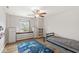 Cozy bedroom with ceiling fan, built-in shelving, and a unique space-themed rug at 7829 Hedgehop Dr, Zionsville, IN 46077