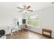 Bright bedroom with large windows, wood floors, and a ceiling fan at 7829 Hedgehop Dr, Zionsville, IN 46077