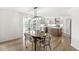 Dining area with a view of the kitchen boasting stainless steel appliances and white subway tile at 7829 Hedgehop Dr, Zionsville, IN 46077