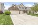 Attractive two-story home with a three-car garage and well-maintained lawn at 7829 Hedgehop Dr, Zionsville, IN 46077