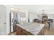 Open-concept kitchen with a granite island, stainless steel appliances, and hardwood floors at 7829 Hedgehop Dr, Zionsville, IN 46077