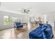 Spacious living room with large windows, an open floor plan, and elegant blue sofa furniture at 7829 Hedgehop Dr, Zionsville, IN 46077