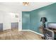 Office area with striking accent wall and doorway view into a hallway featuring gray wainscotting at 7829 Hedgehop Dr, Zionsville, IN 46077