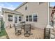 Cozy outdoor patio area featuring comfortable seating, a grill, and access to the sunroom at 7829 Hedgehop Dr, Zionsville, IN 46077