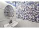 Charming powder room with unique wallpaper, stylish lighting, and a modern sink at 7829 Hedgehop Dr, Zionsville, IN 46077