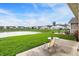 Scenic backyard view showcasing a patio, seating, lush lawn, and a serene pond in a residential neighborhood at 793 Shepherds Way, Greenwood, IN 46143