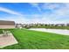 Lush backyard featuring a patio, manicured lawn, and peaceful pond with neighborhood views and a charming dock at 793 Shepherds Way, Greenwood, IN 46143